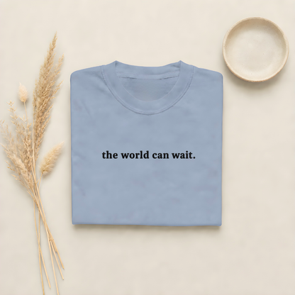 Blue Jean garment-dyed Comfort Colors tee with "the world can wait" embroidered on the chest, Soft Rebellion