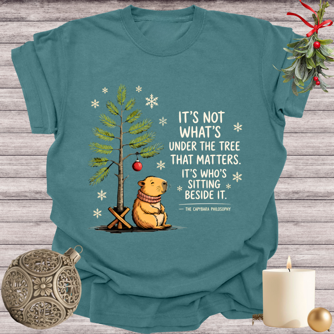 Blue Spruce garment-dyed Comfort Colors tee reading "it's not what's under the tree that matters, it's who's sitting beside it", Soft Rebellion