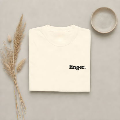 Ivory garment-dyed Comfort Colors tee with "linger" embroidered on the chest, Soft Rebellion