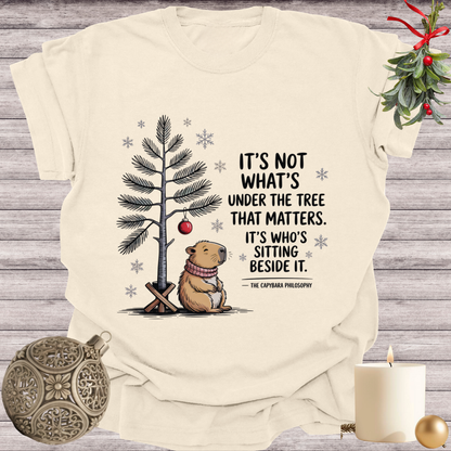 Ivory garment-dyed Comfort Colors tee reading "it's not what's under the tree that matters, it's who's sitting beside it", Soft Rebellion