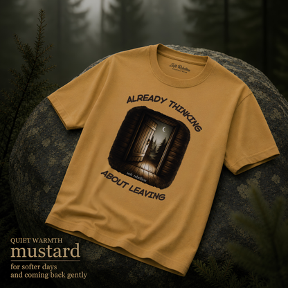 Mustard garment-dyed Comfort Colors tee reading "Already Thinking About Leaving", Soft Rebellion