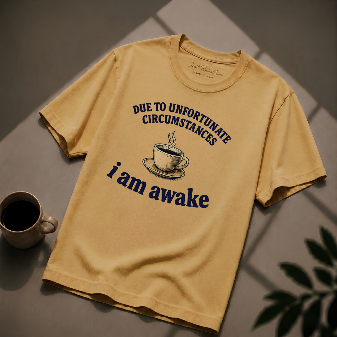 Mustard garment-dyed Comfort Colors tee reading "Due to Unfortunate Circumstances I Am Awake", Soft Rebellion