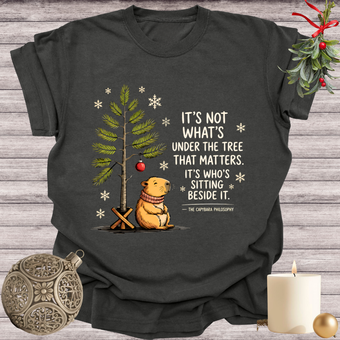 Pepper garment-dyed Comfort Colors tee reading "it's not what's under the tree that matters, it's who's sitting beside it", Soft Rebellion