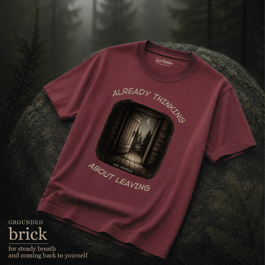 Brick garment-dyed Comfort Colors tee reading "Already Thinking About Leaving", Soft Rebellion