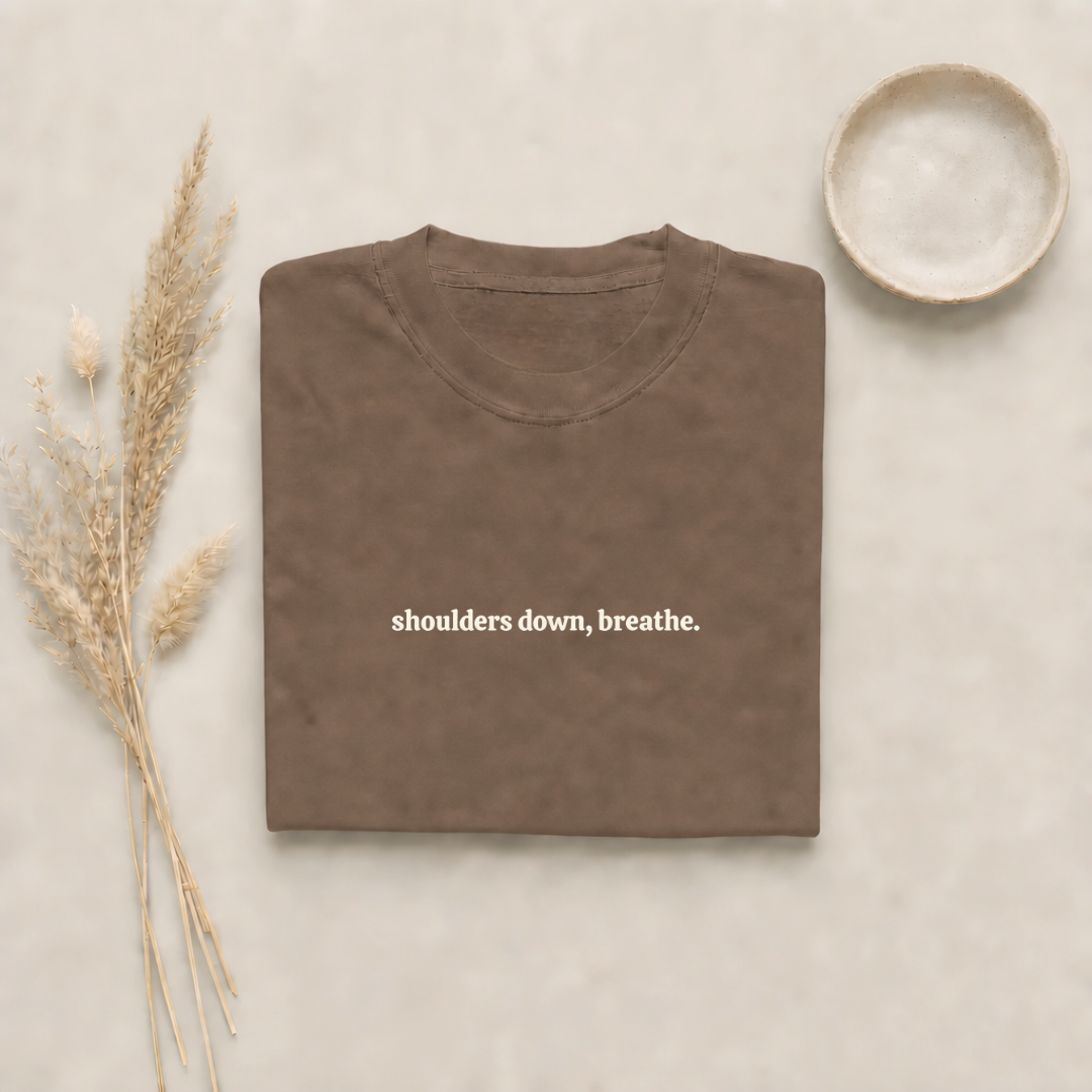 Espresso garment-dyed Comfort Colors tee with "shoulders down, breathe" embroidered on the chest, Soft Rebellion