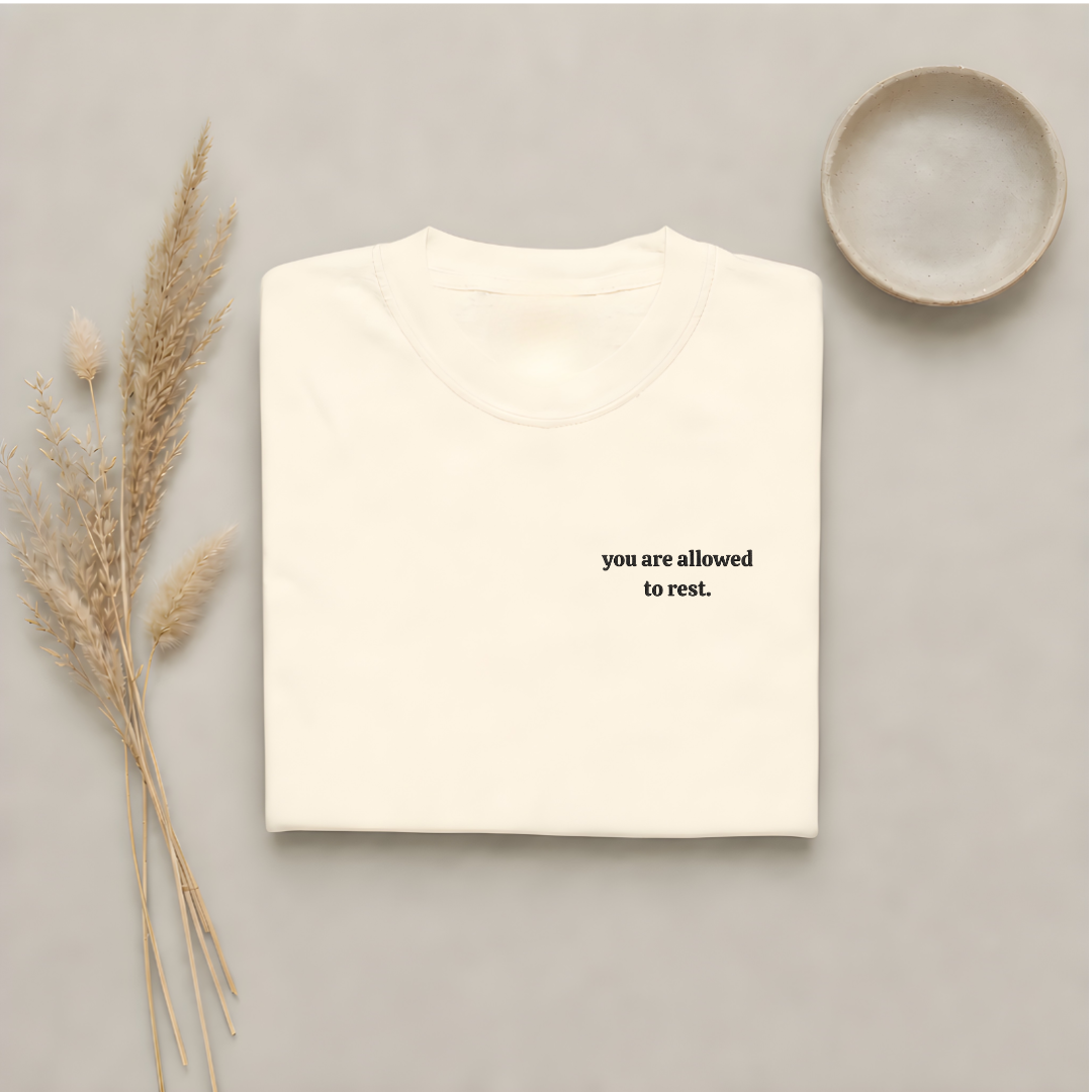 Ivory garment-dyed Comfort Colors tee with "you are allowed to rest" embroidered on the chest, Soft Rebellion