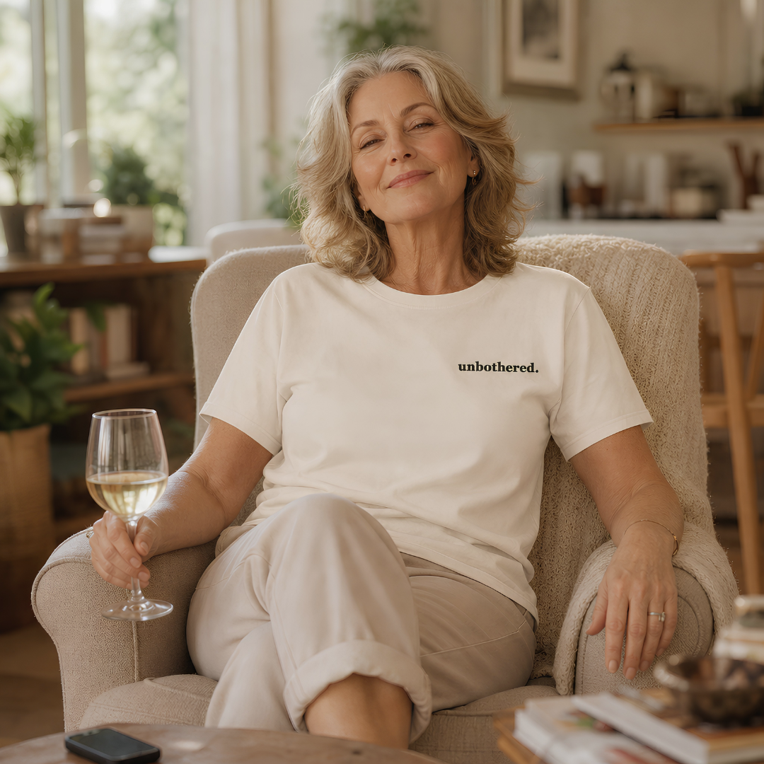 Ivory garment-dyed Comfort Colors tee with "unbothered" embroidered on the chest, Soft Rebellion