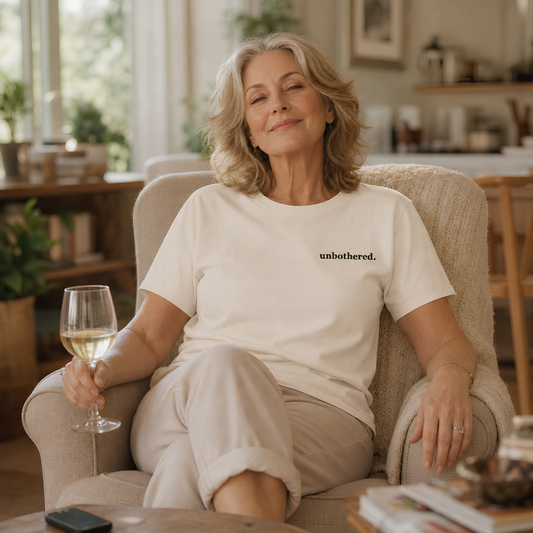 Ivory garment-dyed Comfort Colors tee with "unbothered" embroidered on the chest, Soft Rebellion