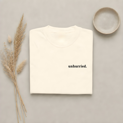 Ivory garment-dyed Comfort Colors tee with "unhurried" embroidered on the chest, Soft Rebellion