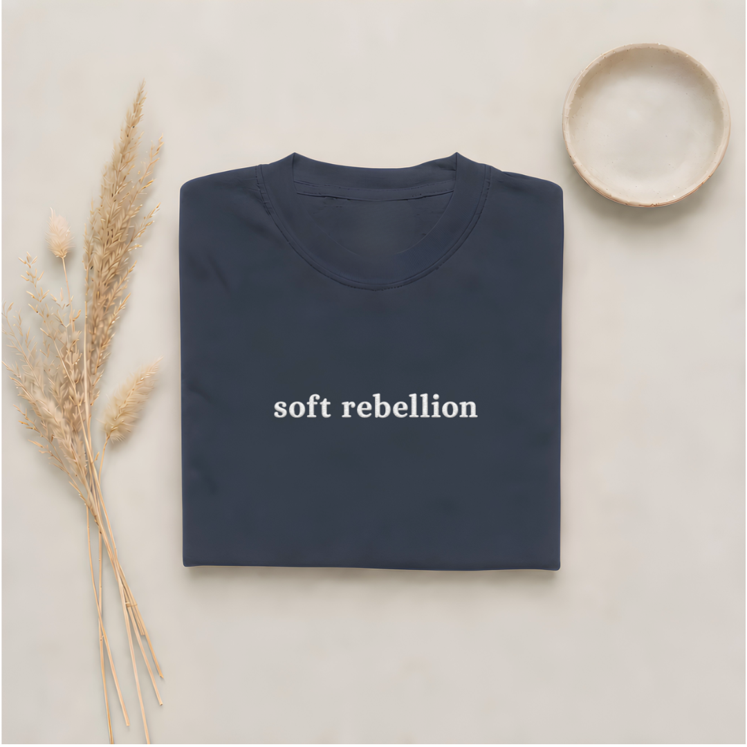 Navy garment-dyed Comfort Colors tee with Soft Rebellion embroidered on the center chest